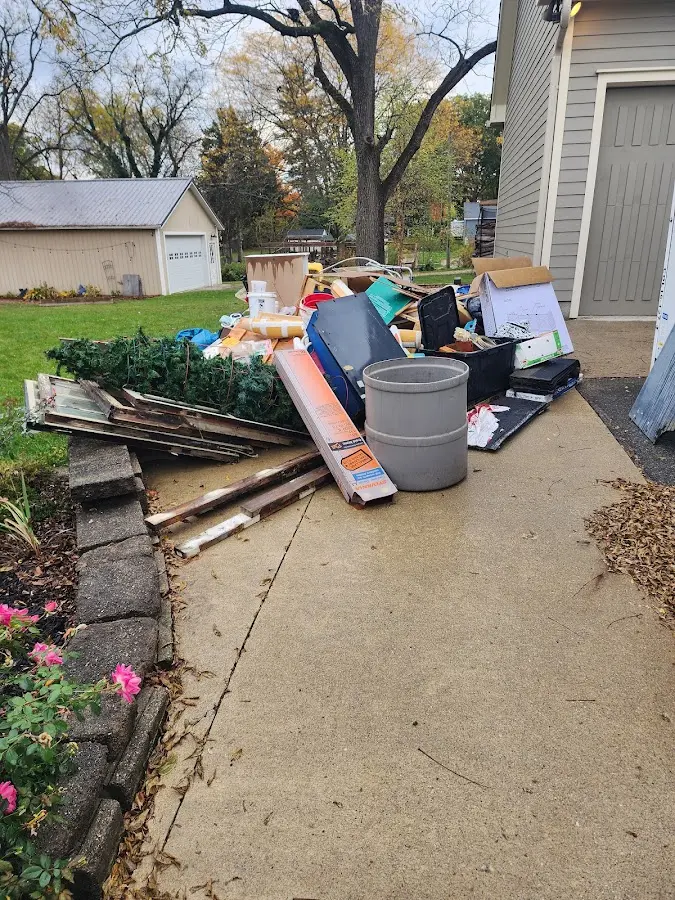 Dumpster being loaded with debris for Roofing Dumpster Rental in Green Forest
